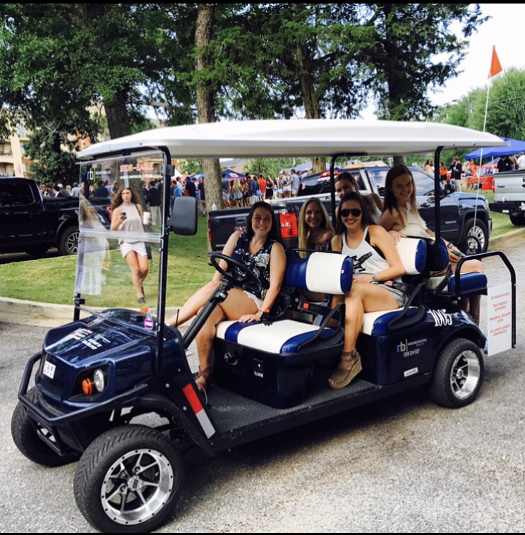Riders enjoying a Grab-a-Cart shuttle at an Auburn tailgate